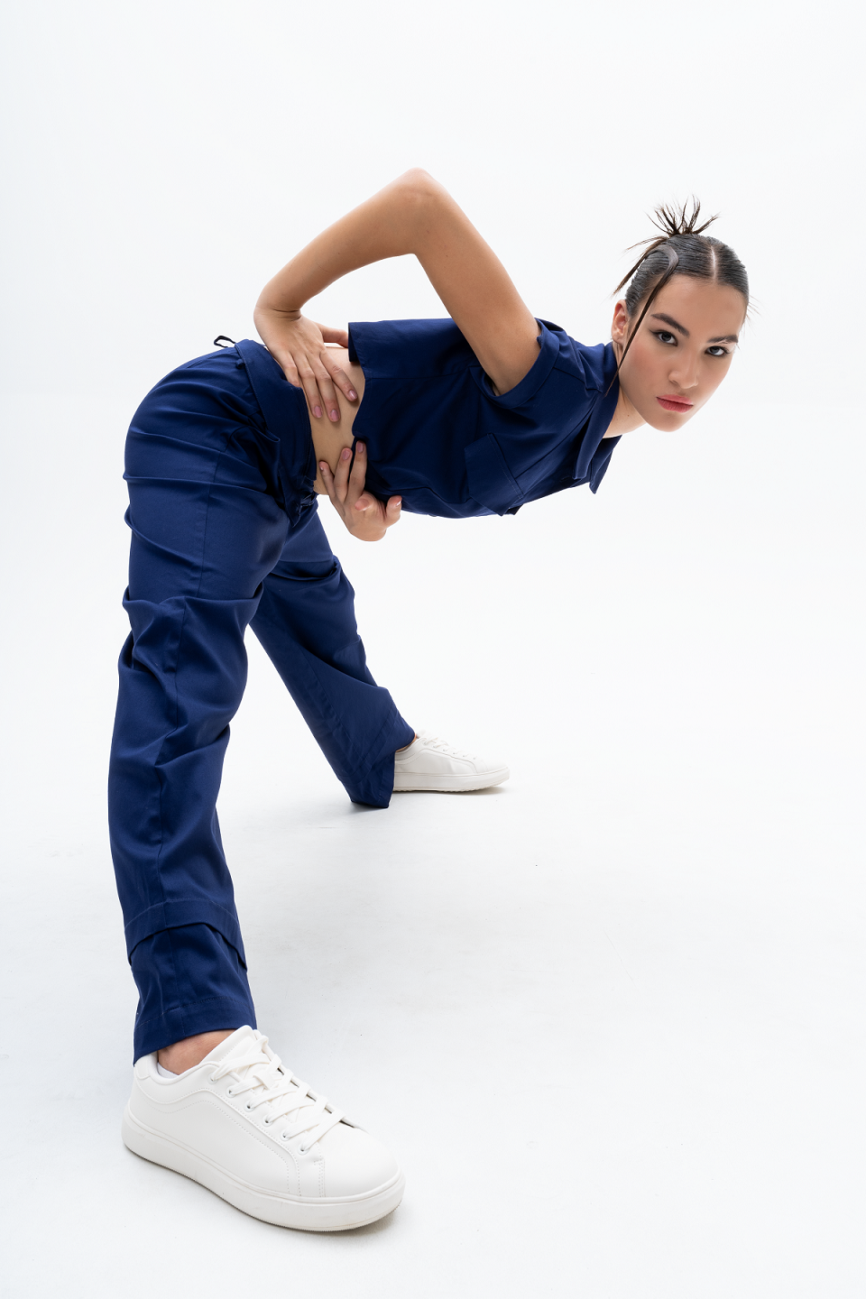 Model wearing AKANTARA Brown and Navy Pants, styled with the Cropped Short Sleeve Vest