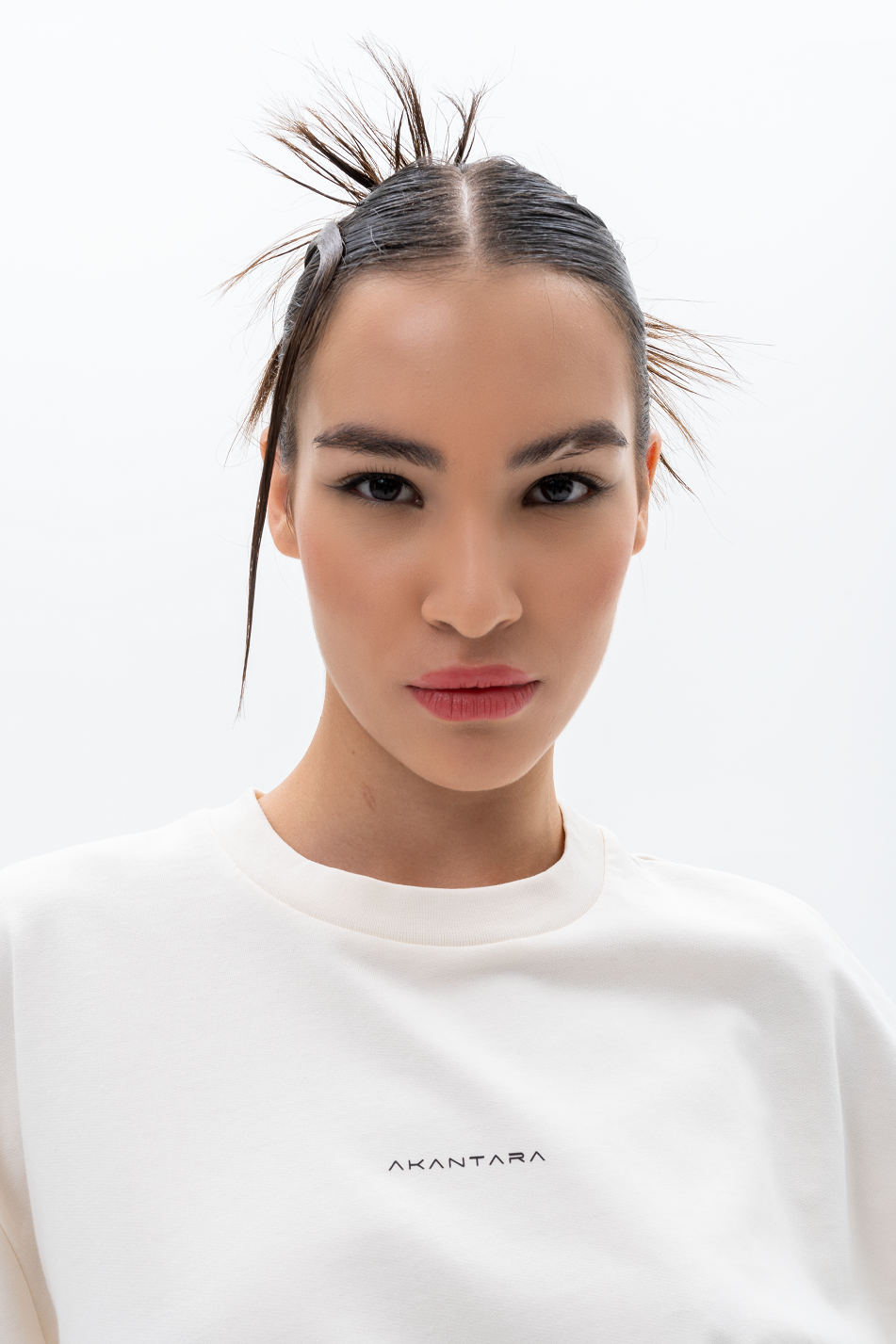 Model wearing AKANTARA Faded Skulls Print T-Shirt, styled with casual streetwear